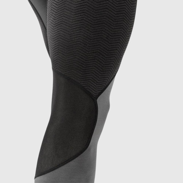 Close-up of the lower leg area showing zigzag textured and mesh panel details for breathability.