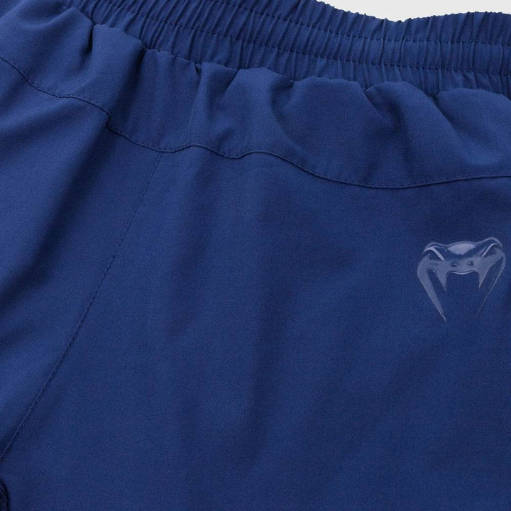 Detailed view of the front waistband of the navy shorts featuring Venum’s snakehead logo in tonal print.