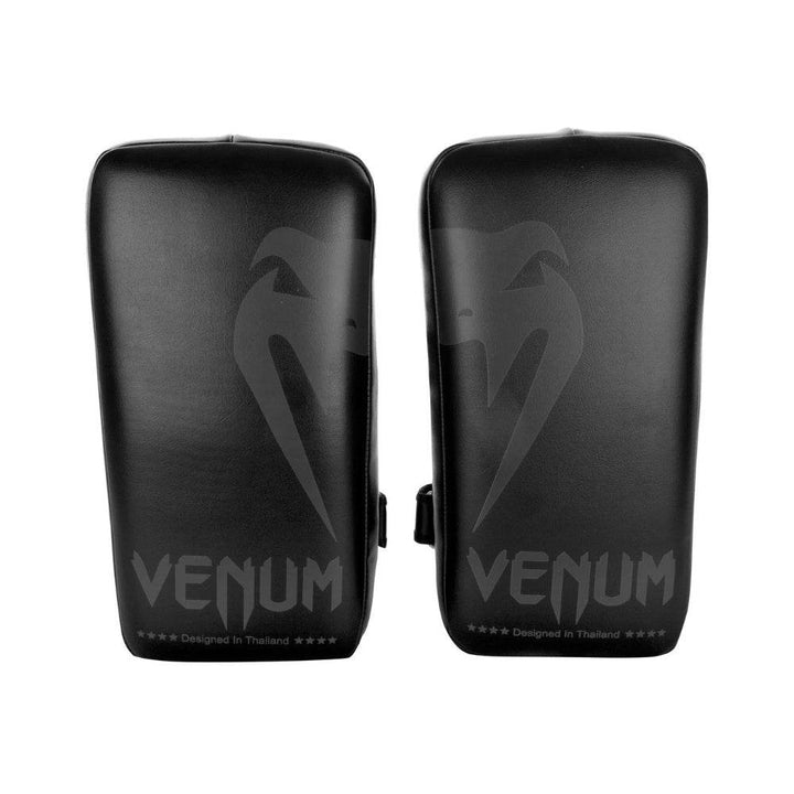 Front view of a pair of black Venum Thai pads featuring the Venum snake logo and “Designed in Thailand” branding at the bottom.