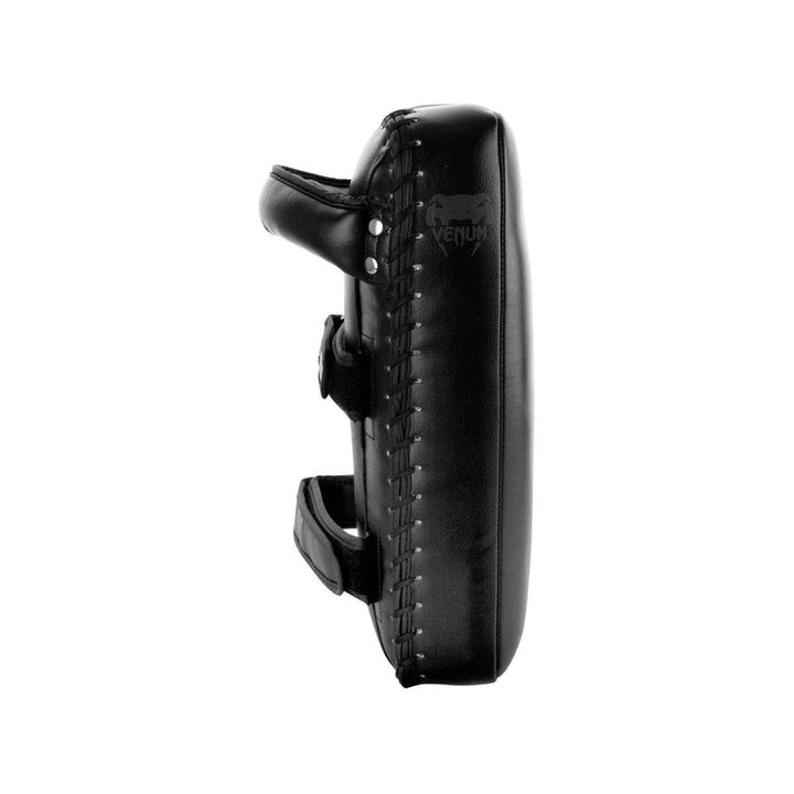 Side profile of a single Venum Thai pad showcasing its thickness, durable stitching, and subtle embossed logo on the edge.