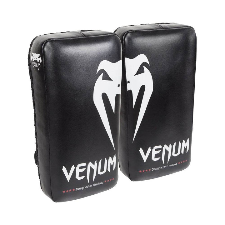 Pair of Venum Giant Kick Pads in black featuring a bold white snake logo and "Venum" branding with "Designed in Thailand" printed below.