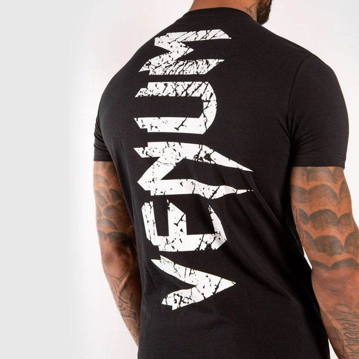 Close-up view of distressed vertical "VENUM" print on the upper back.