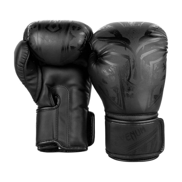 Rear and palm view of the black Gladiator 3.0 gloves, right glove angled inward to reveal curved thumb and “VENUM” logo.