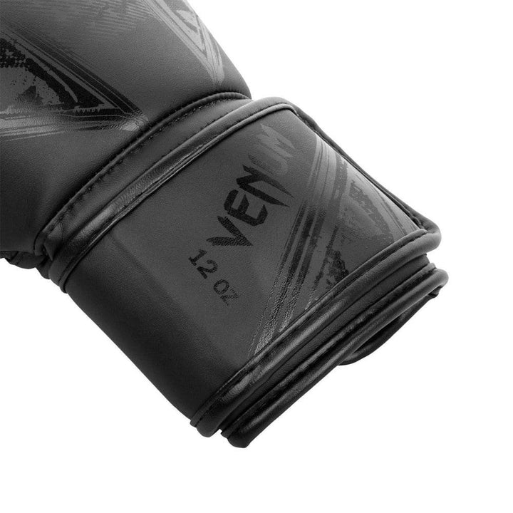 Close-up of wrist strap on Gladiator 3.0 glove, with subtle embossed “VENUM” text and “12 oz” weight marking.