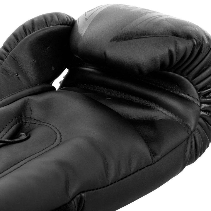 Palm-side macro of Gladiator 3.0 glove showing perforated finger ridge, padded grip bar, and matte black finish.