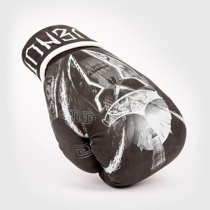 Single Gladiator 4.0 glove resting on knuckles, showing sweeping white battle-helmet artwork across top panel.