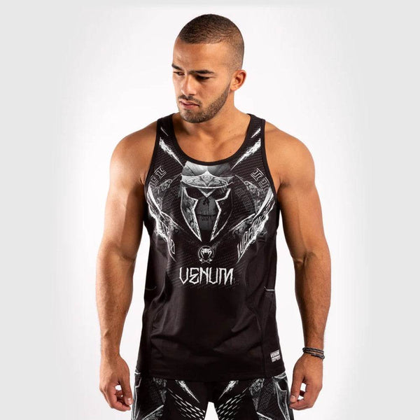 Front view of a male model wearing a black Venum Gladiator tank top with a detailed gladiator helmet graphic and “VENUM” branding.