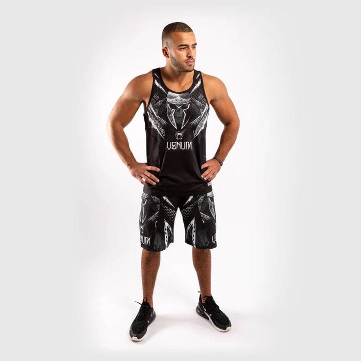 Full body shot of model standing with hands on hips, wearing the tank top and matching shorts.