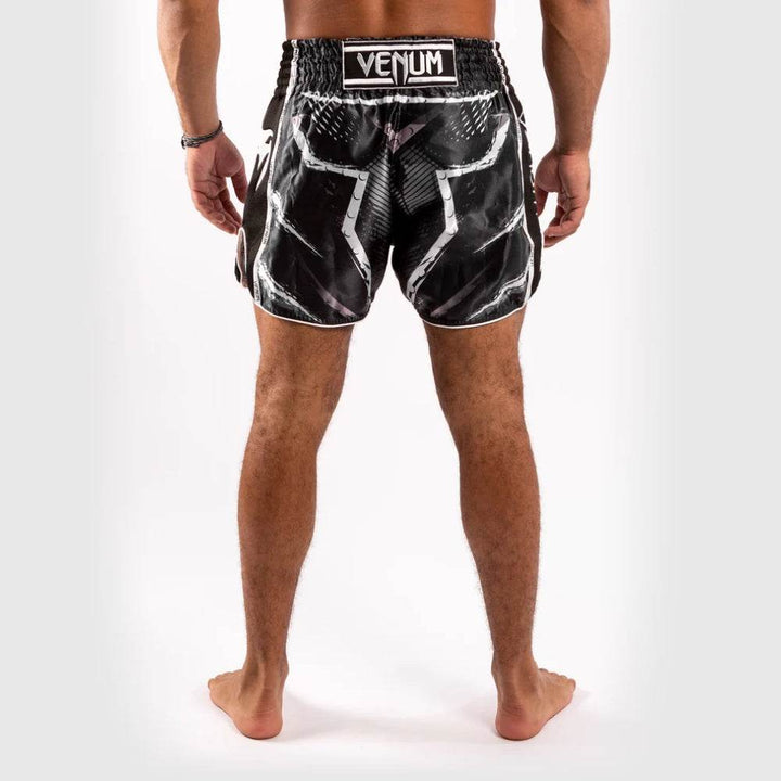 Rear view showing white-outlined graphic design and Venum patch on waistband.