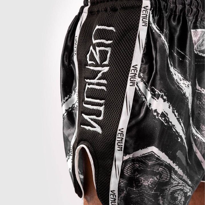 Side detail of white vertical "VENUM" branding on black mesh.