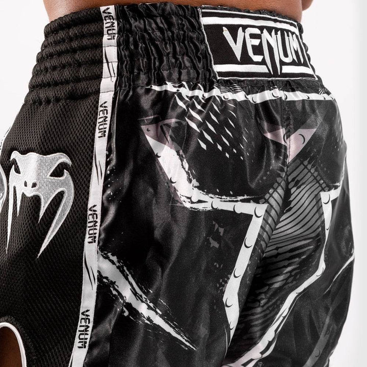 Close-up of white Venum snake logo printed on side mesh panel.