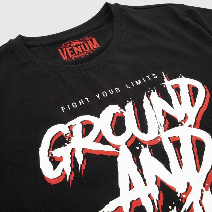 Close-up of the Venum MMA t-shirt showing detailed “GROUND AND POUND” graphic text with a red underlay and the slogan “FIGHT YOUR LIMITS” above it.