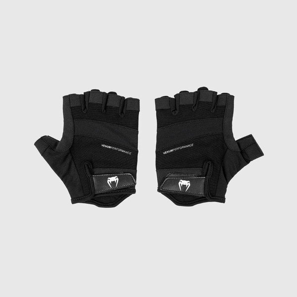 Pair of black Venum Performance weightlifting gloves shown from the top side, featuring half-finger coverage and Velcro strap with Venum snake logo.