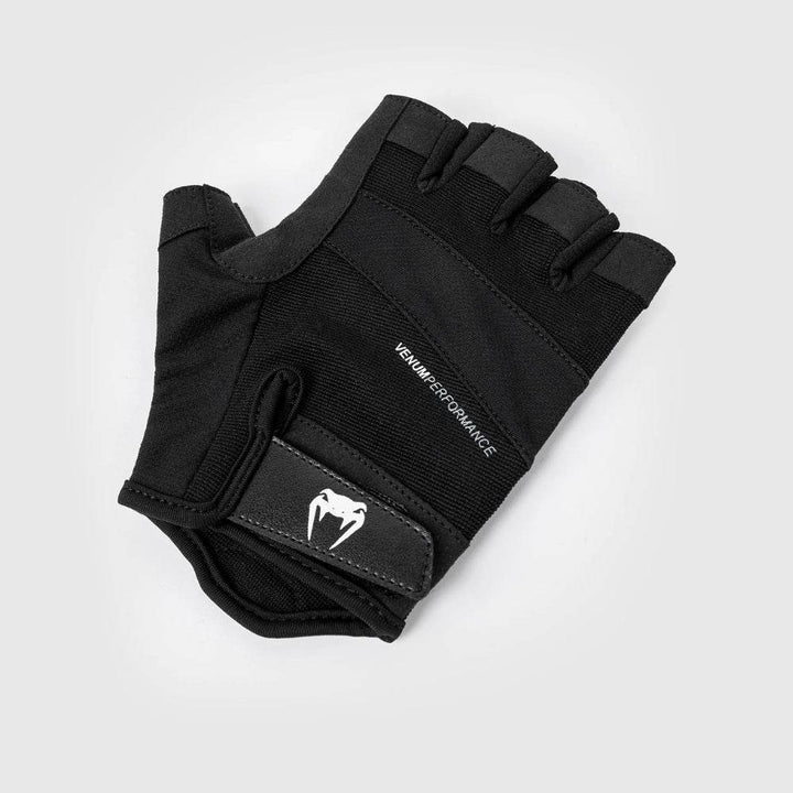 Side view of a single black Venum Performance glove, showcasing wrist strap with Venum logo and flexible backhand material.