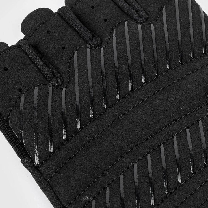 Macro close-up of the glove's palm grip area, detailing the synthetic suede padding and diagonal rubberized grip strips.