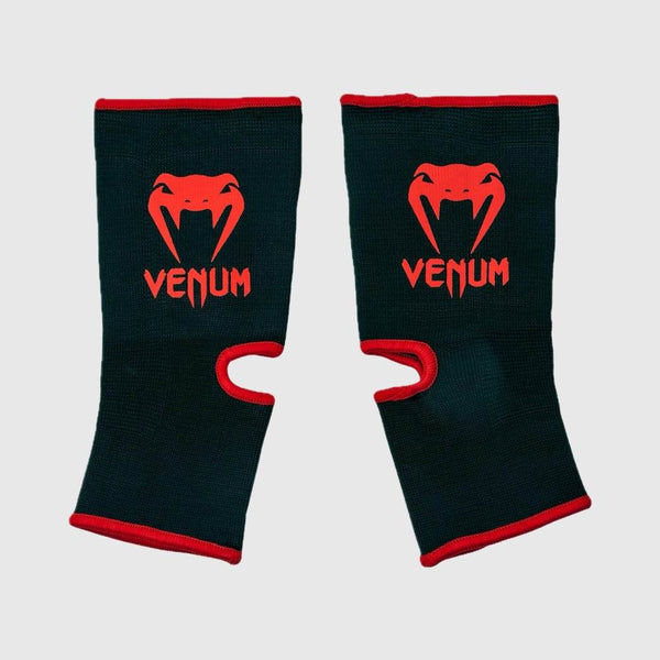 Pair of Venum ankle supports with red Venum logos and trim, top side facing up.