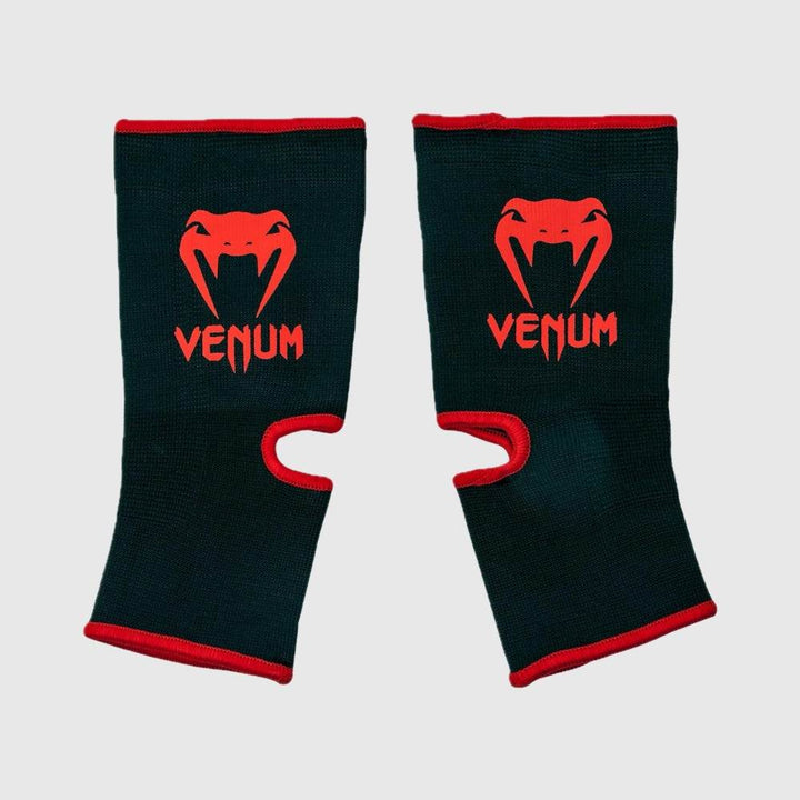 Pair of Venum ankle supports with red Venum logos and trim, top side facing up.