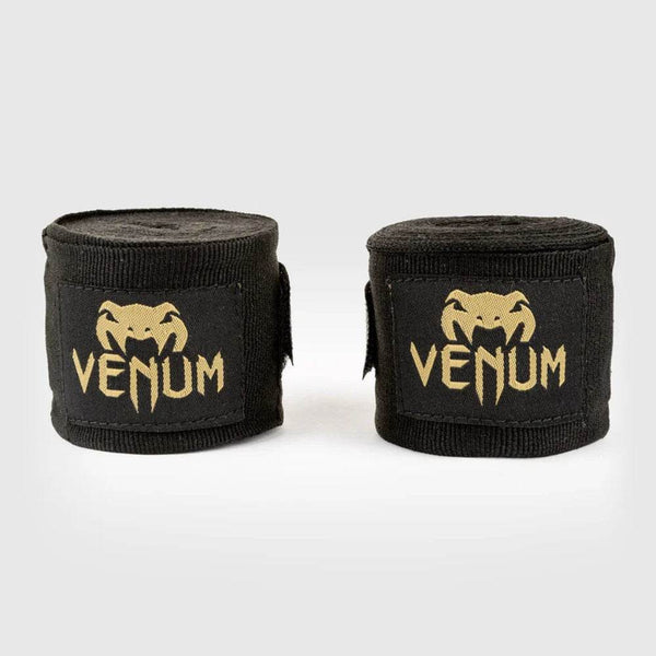 Black handwraps with gold Venum logo, rolled and unrolled.