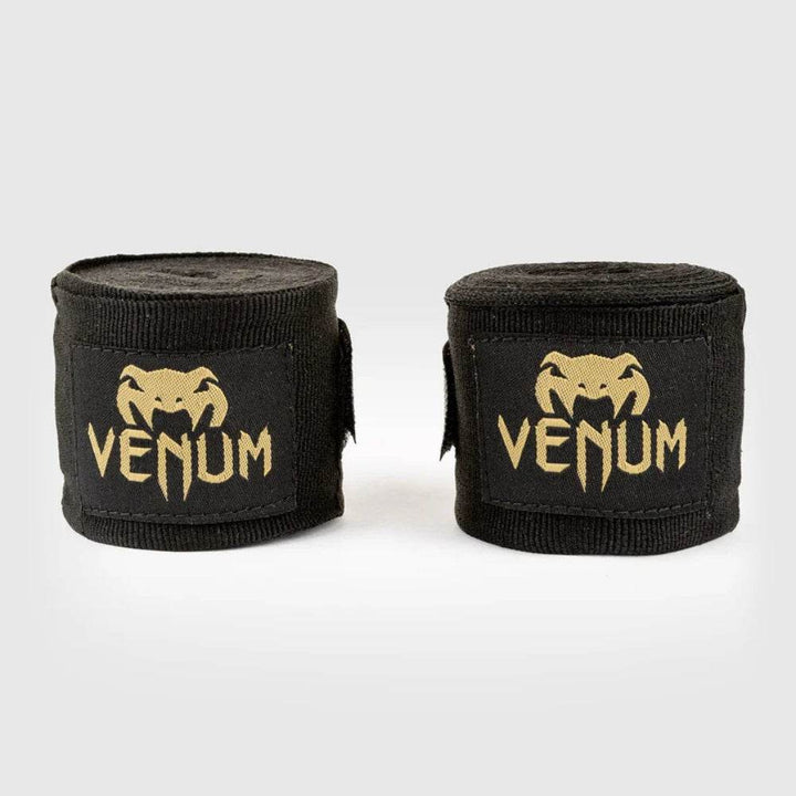 Black handwraps with gold Venum logo, rolled and unrolled.