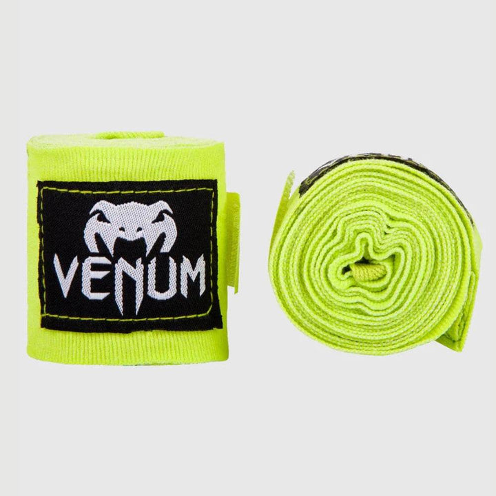 Neon yellow handwraps with black and white logo patch.