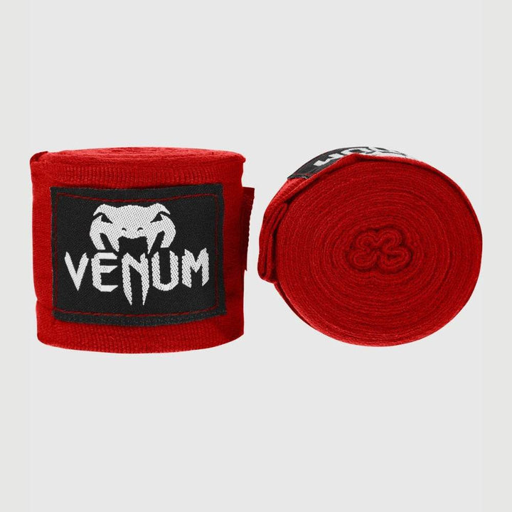 Red handwraps with white Venum branding, compact roll.