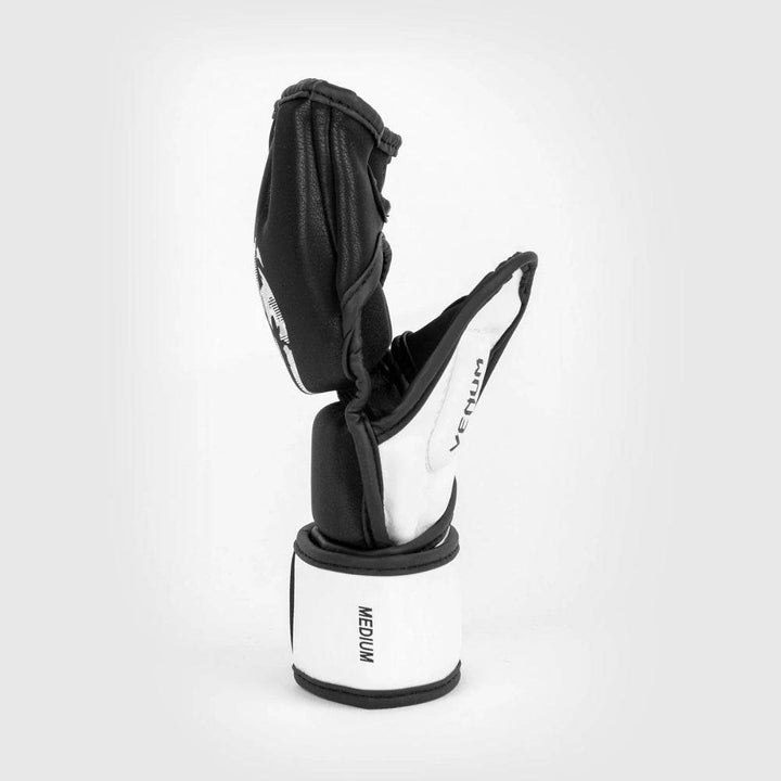 Profile view of the Venum Legacy MMA glove showing the wraparound strap and ergonomic construction with reinforced stitching along the thumb and palm.
