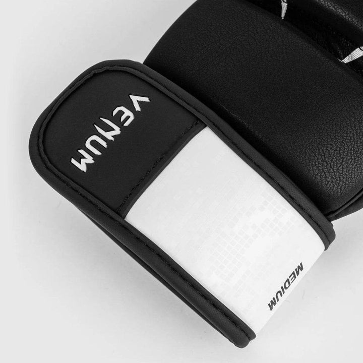 Detailed view of the Venum logo stitched in white on the wrist strap, with textured leather material and clean finish.