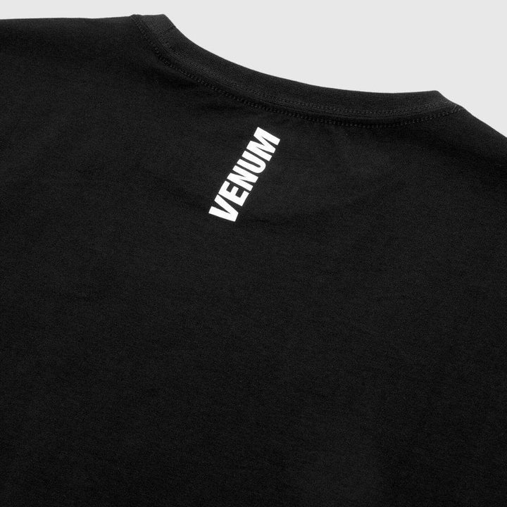 Close-up of the white Venum logo printed below the back neckline.