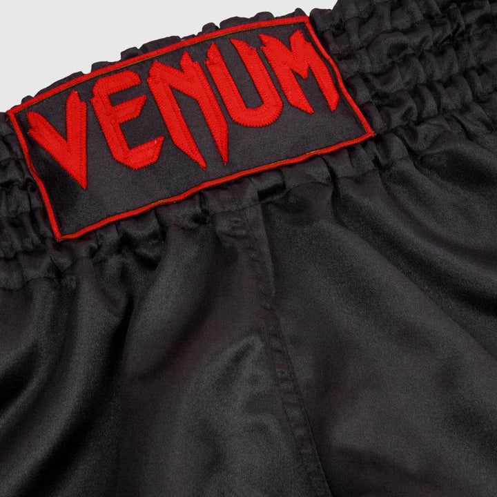 Red embroidered Venum logo on thick black elastic waistband.
