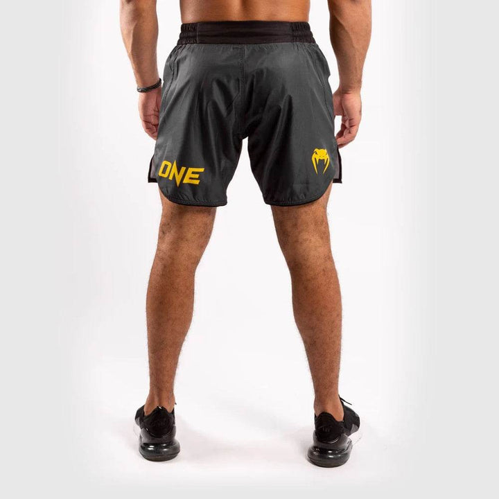 “ONE” logo in yellow on the right leg and Venum snakehead logo on the left leg, positioned on the back hem.