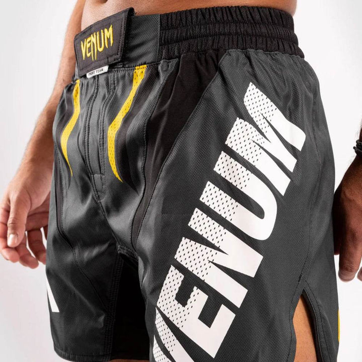 Detailed view of the front waist with yellow claw-stripe designs, black hook-and-loop closure, and "VENUM" label patch.