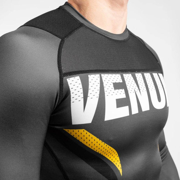 Zoomed view of the VENUM chest logo and detailed yellow fang-style graphic.