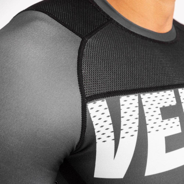 Close-up of mesh shoulder panel and upper “VENUM” logo section.