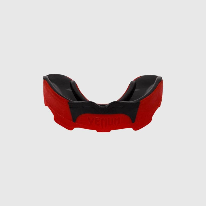Red and black Venum Predator mouthguard with black gel interior, showing front curve and logo embossed on the front.