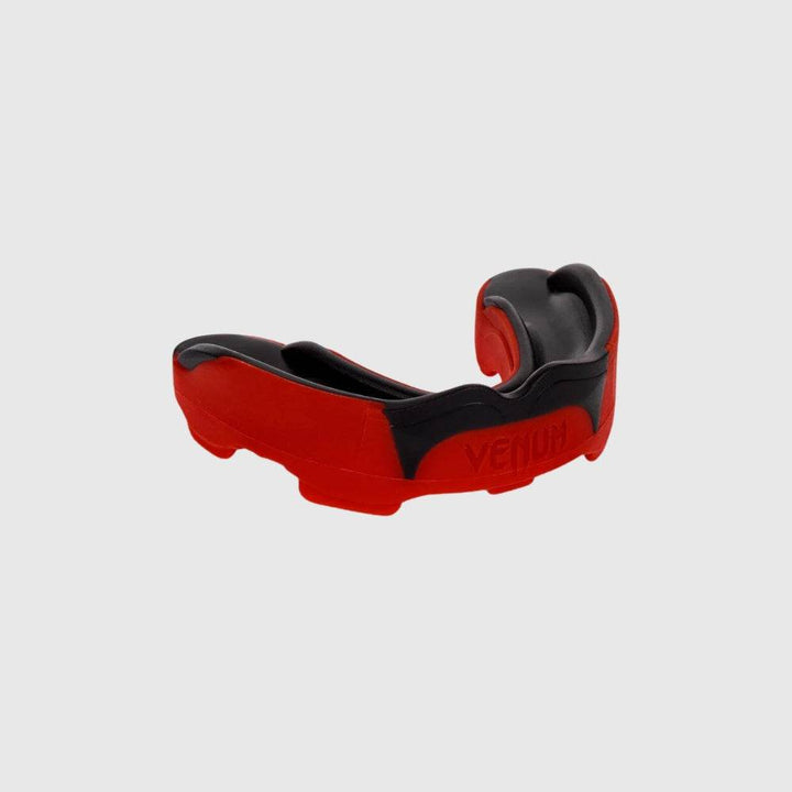 Side profile of the red and black Venum Predator mouthguard emphasizing its contoured build and reinforced side panels.