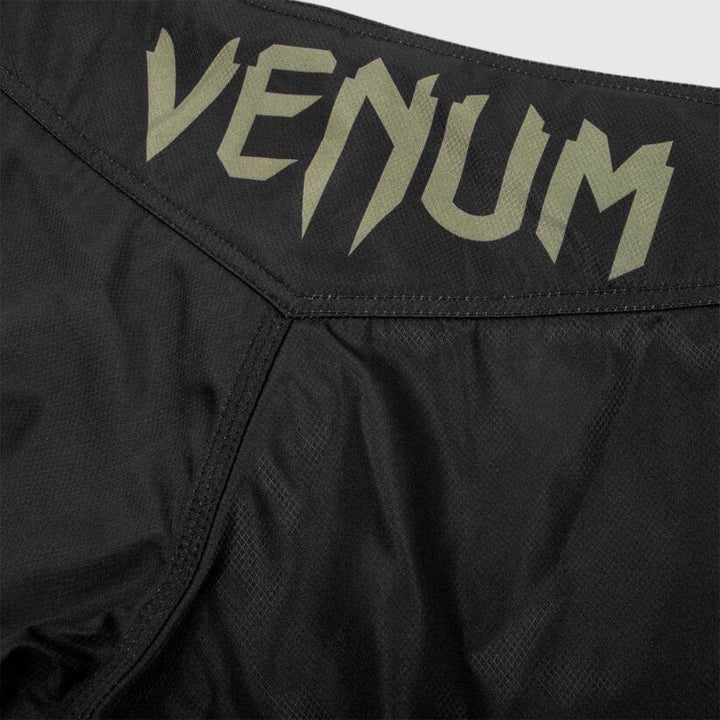 Rear waistband close-up with centered green Venum logo.