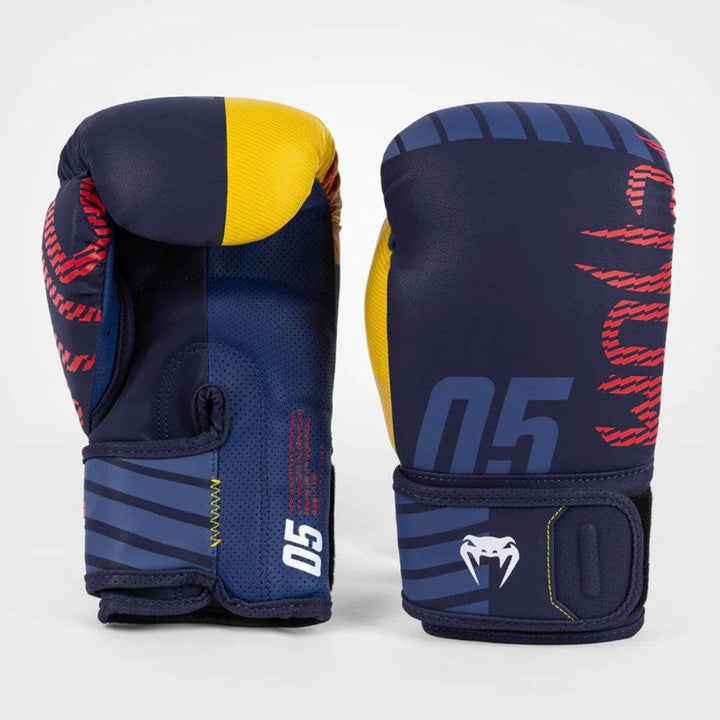 Rear and front view of the gloves displaying the ventilated palm mesh, red stitching, and bold color-block design.