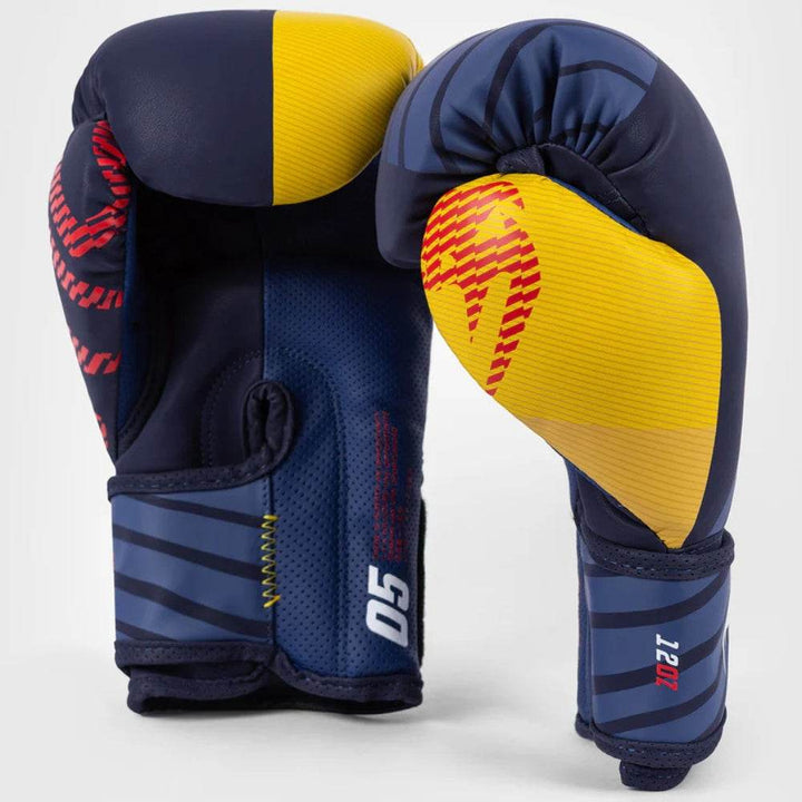 Side and front view of the gloves displaying the ventilated palm mesh, red stitching, and bold color-block design.