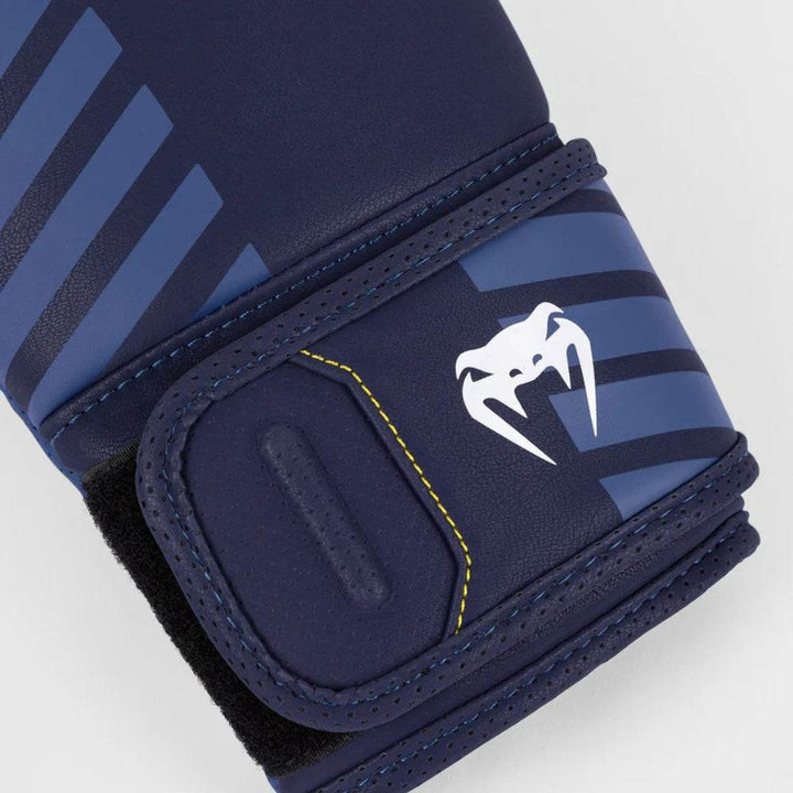 Close-up of the wrist strap featuring a white Venum snakehead logo and contrasting yellow stitching detail.
