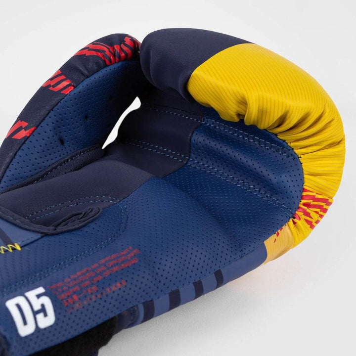 Interior view of the glove showcasing perforated navy mesh and red inner design with stitching across the palm.