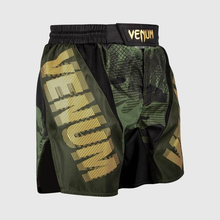 Angled view of Venum camo shorts showing the golden vertical branding on each leg and high-mobility cut.