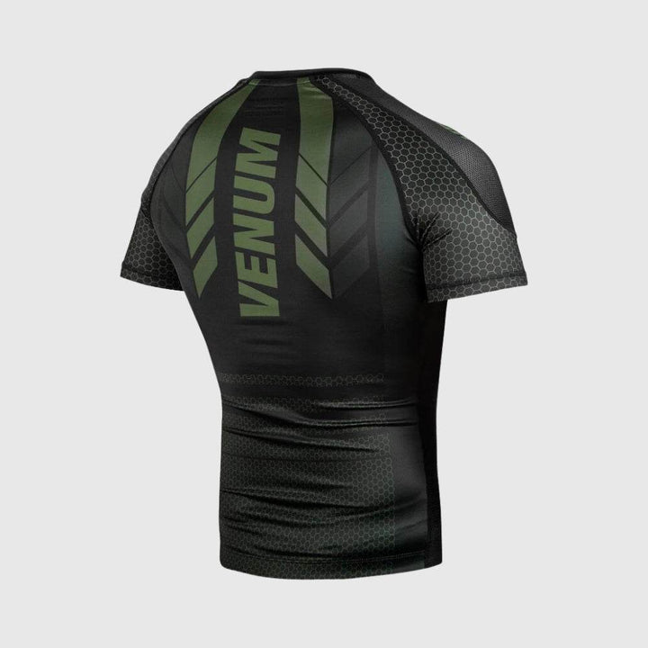 Angled back view of the Venum rashguard displaying green diagonal stripe graphics and bold "VENUM" logo across the upper back.