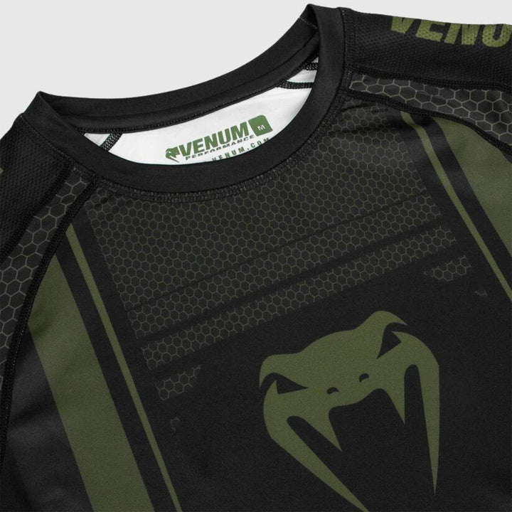 Detail shot of the collar and upper chest area showing Venum logo print on the inside tag and honeycomb pattern on shoulders.