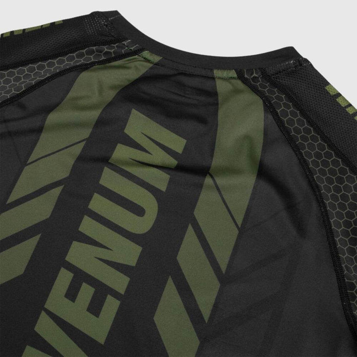 Close-up of the upper back showing VENUM print across the shoulders and green chevron-style graphics.