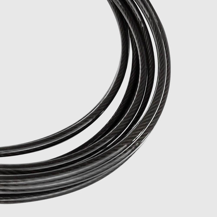 Macro shot of the coiled black steel cable on the Venum speed rope, highlighting its durability and coated finish.