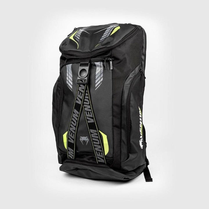 Front view of the Venum backpack standing upright, fully zipped with dual front straps featuring VENUM branding and contrasting neon accents for a bold athletic look.