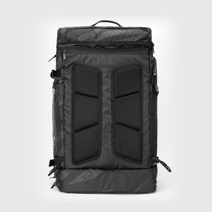 Back panel view of the UFC Fight Week Performance Kit bag by Venum, featuring padded mesh support zones for airflow and comfort, with full-length zippers on both sides.