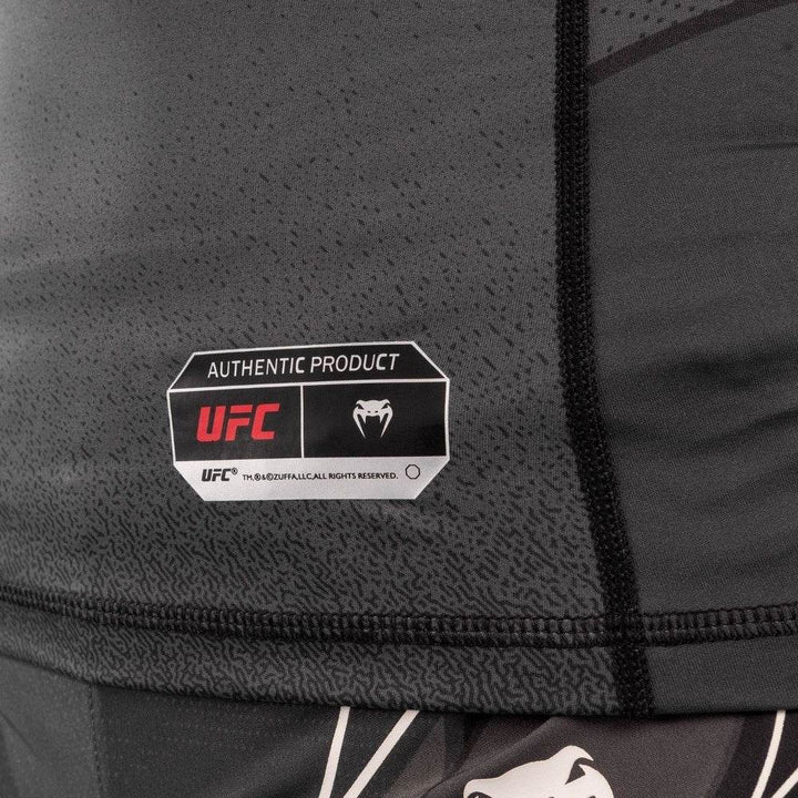 Detail of "Authentic Product" label on bottom hem of rash guard.