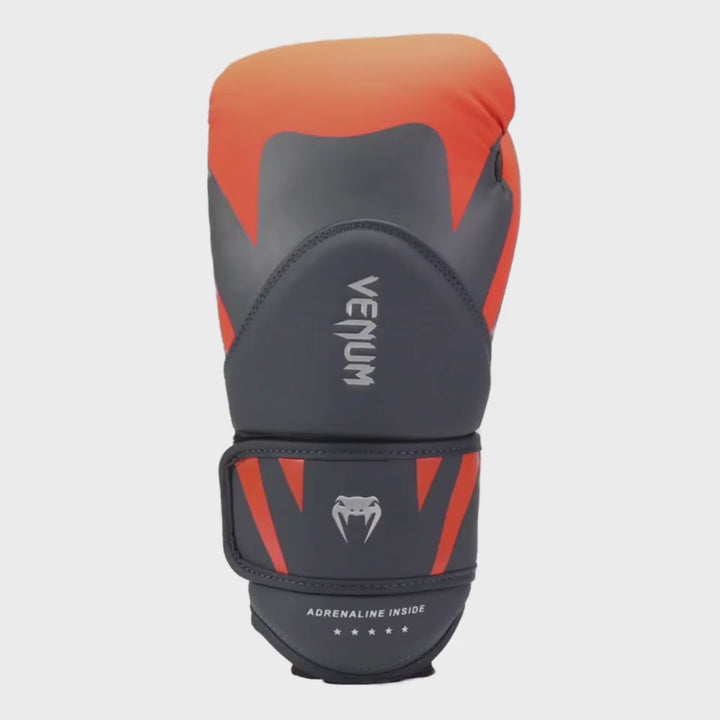 360 degree video of Venum Challenger 4.0 boxing glove in matte grey with vibrant orange top padding and accents, featuring the Venum logo vertically on the glove and “Adrenaline Inside” text on the wrist strap.